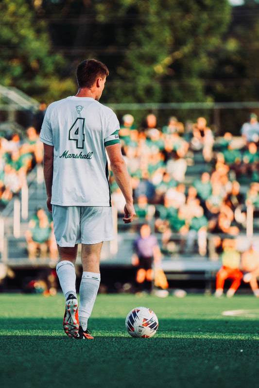 Athlete wearing Immerse Performance grip socks with team socks using the sleeve method