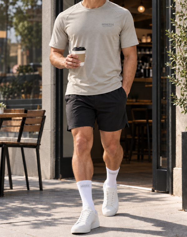 Walking out of a cafe with coffee in white Immerse crew socks